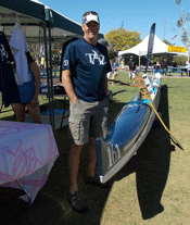 picture of helping standing by outrigger canoe