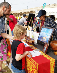 Family checking out display for Hawaiian voyaging canoes
